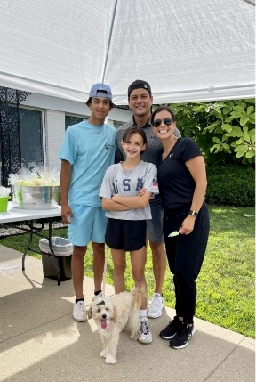 Family of four with dog at community event