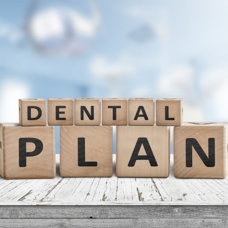 Wooden letter blocks spelling out the words dental plan
