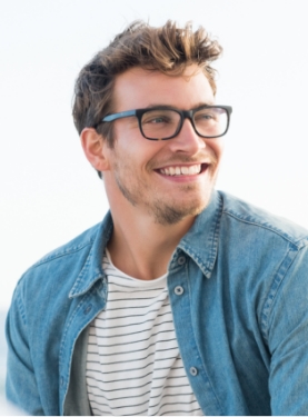 Smiling young man wearing glasses and denim shirt